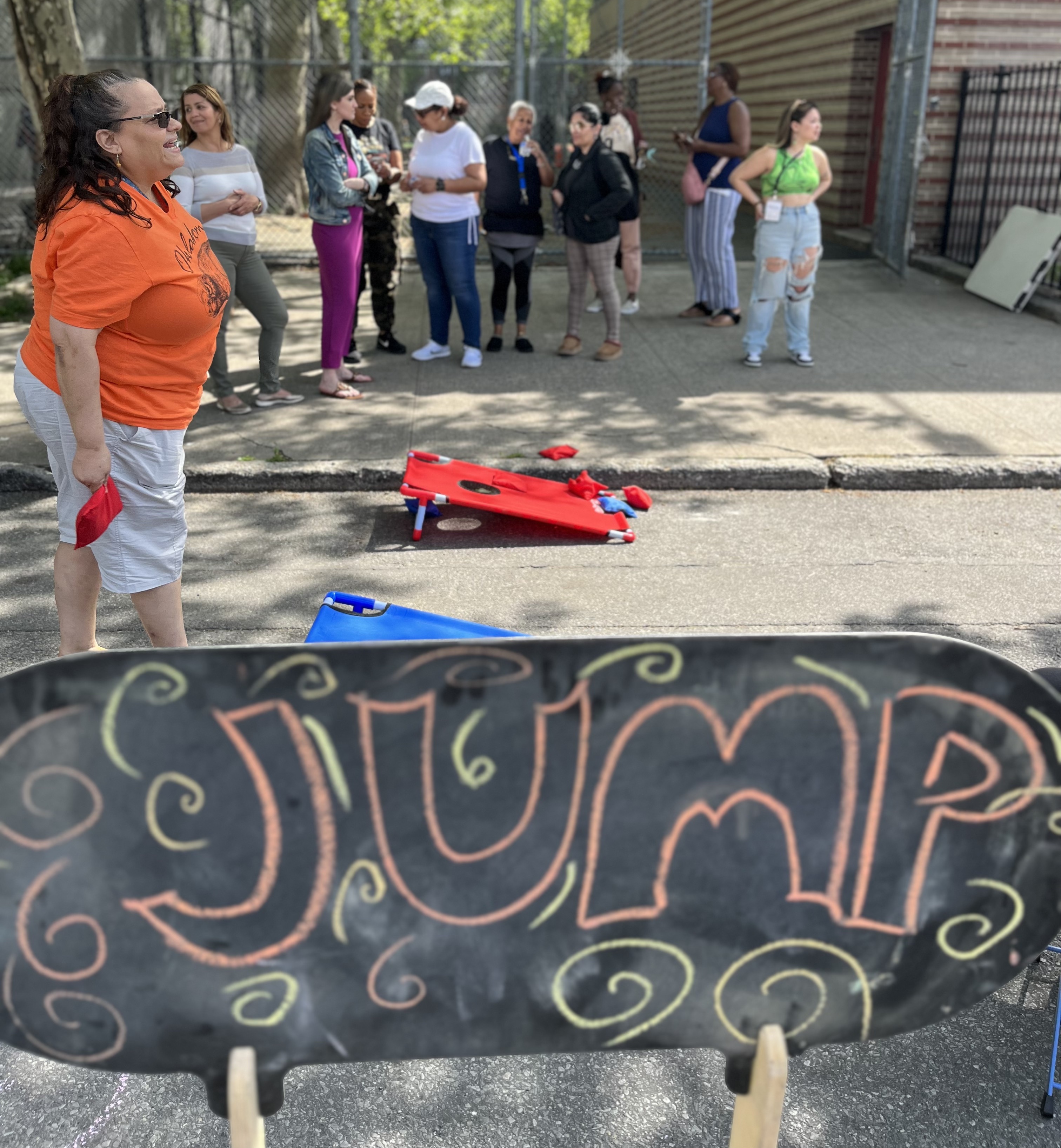 Community members gathered for outdoor activities with games and chalk art