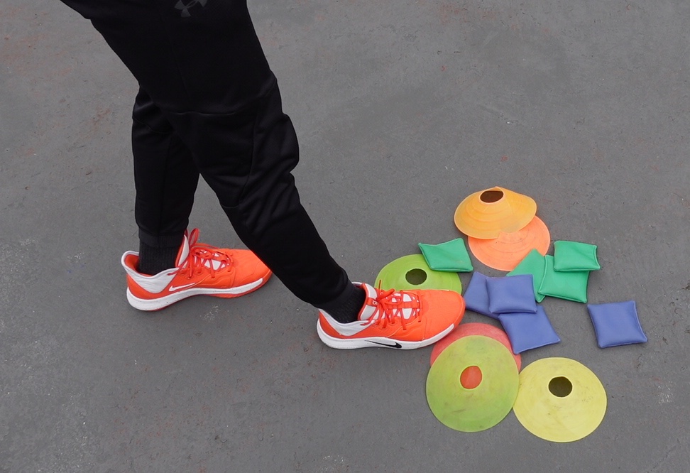 Colorful physical education equipment with orange cones and activity markers