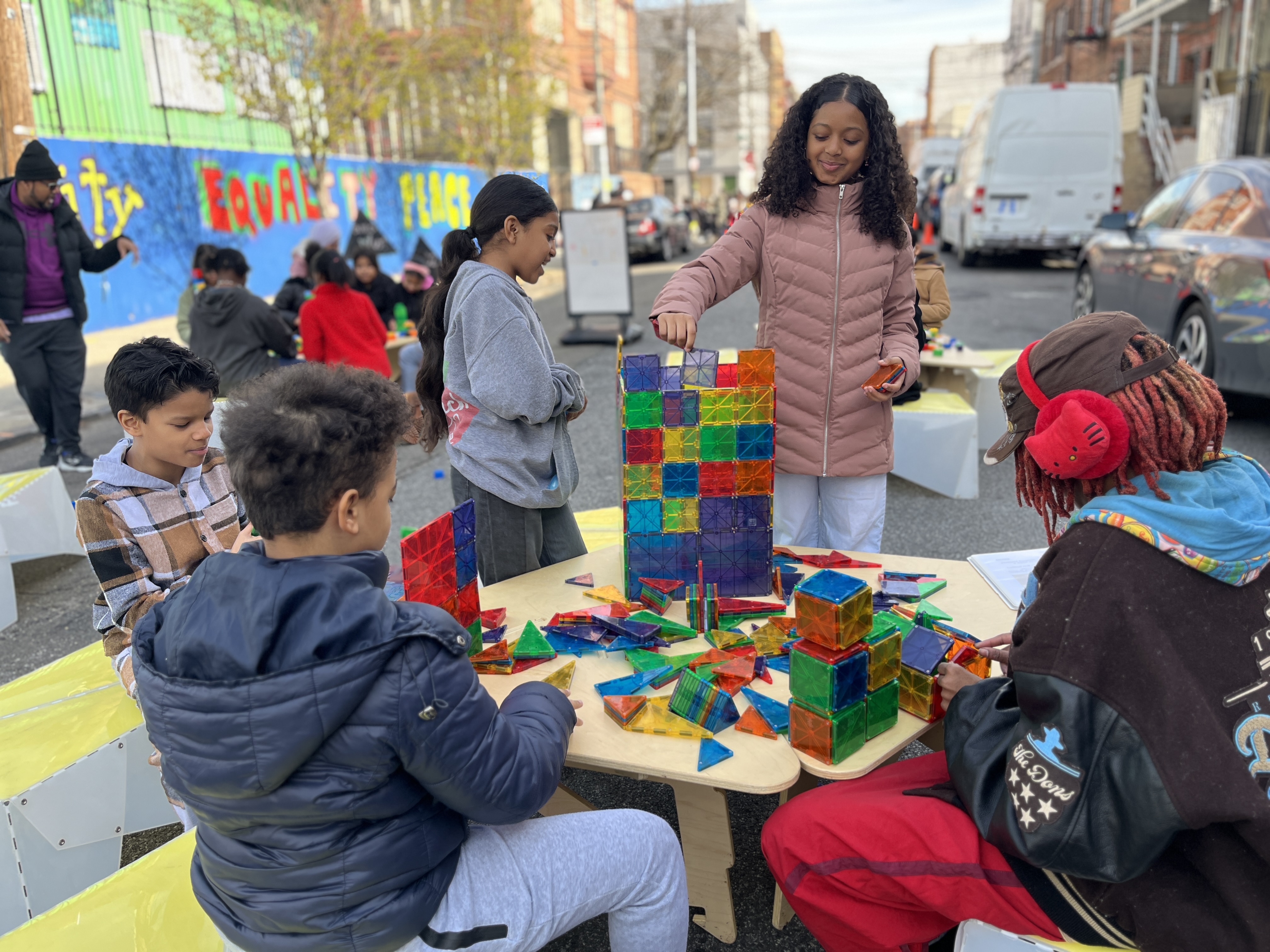 Children building with colorful magnetic tiles at a community event
