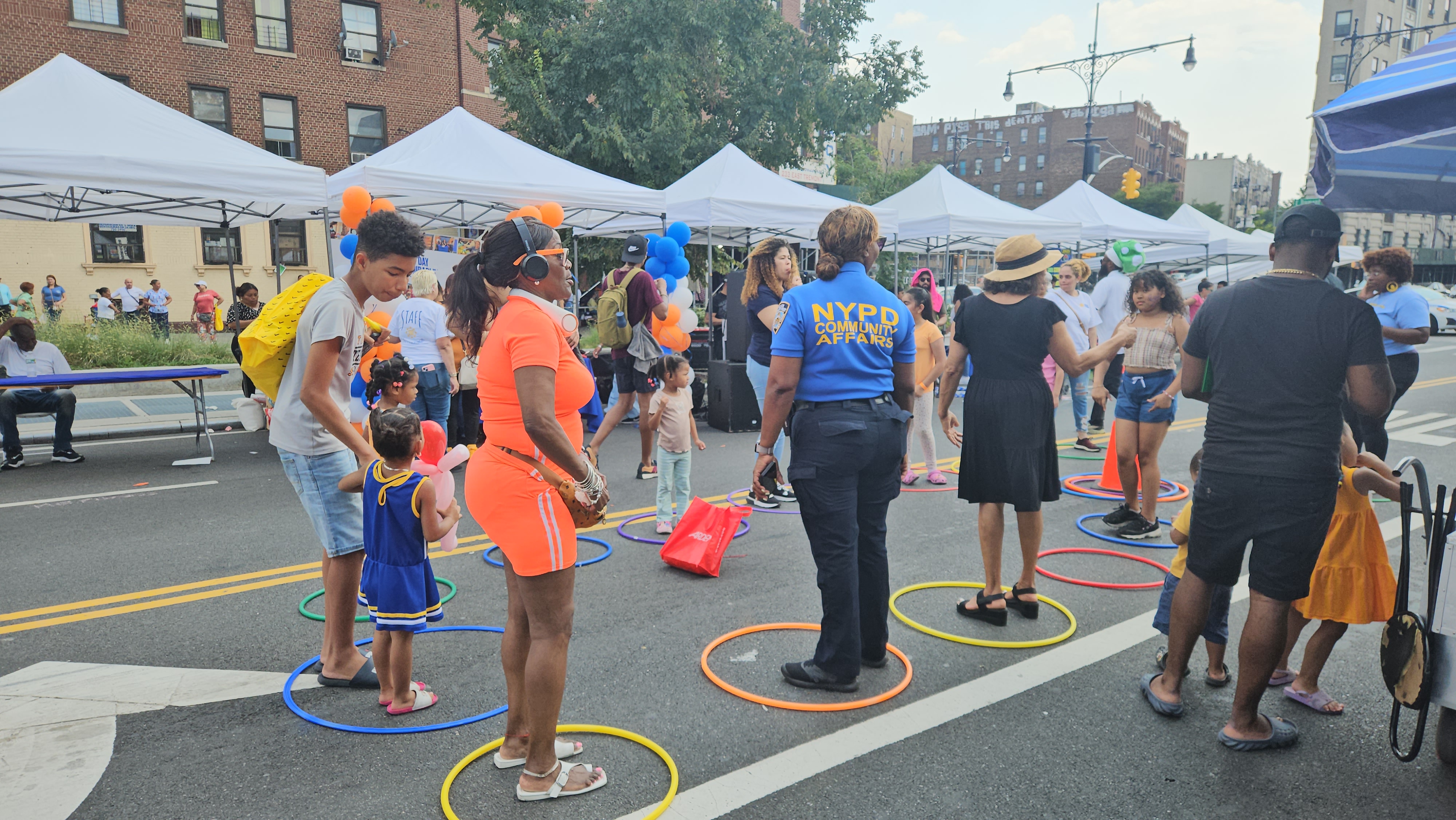 Community street event with colorful hula hoops and activity stations
