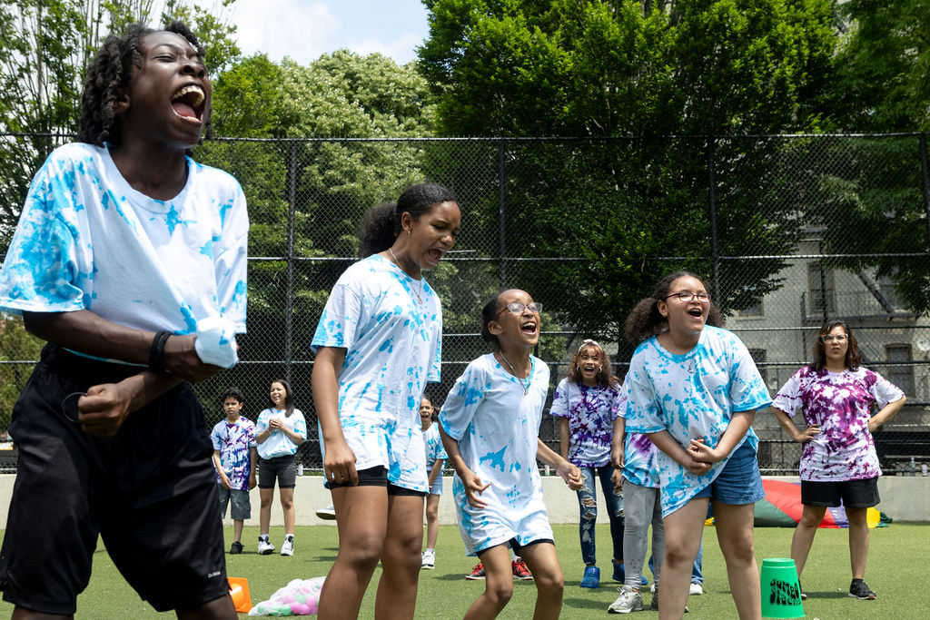Children enjoying outdoor activities in tie-dye shirts