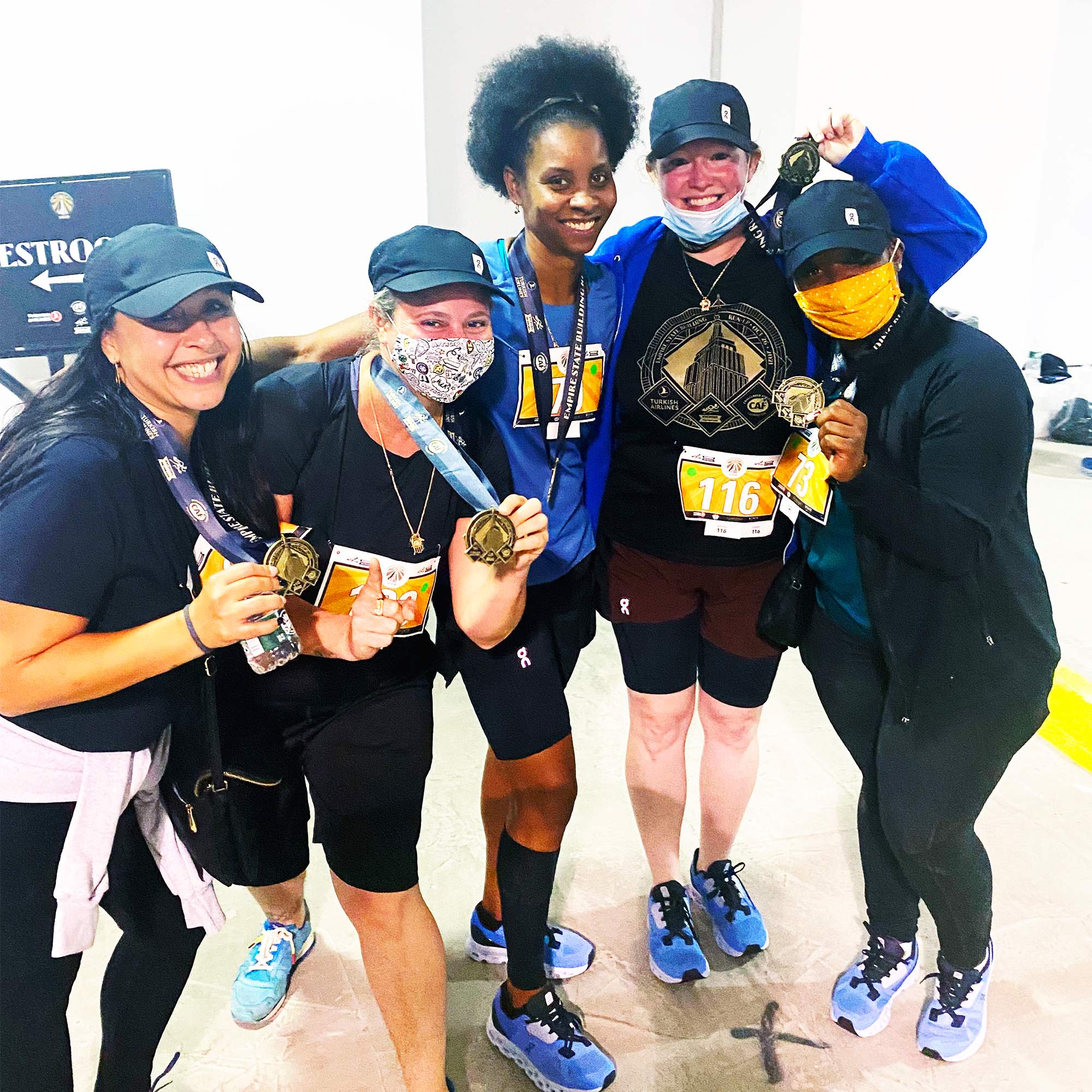 Group of runners celebrating with medals after completing a race