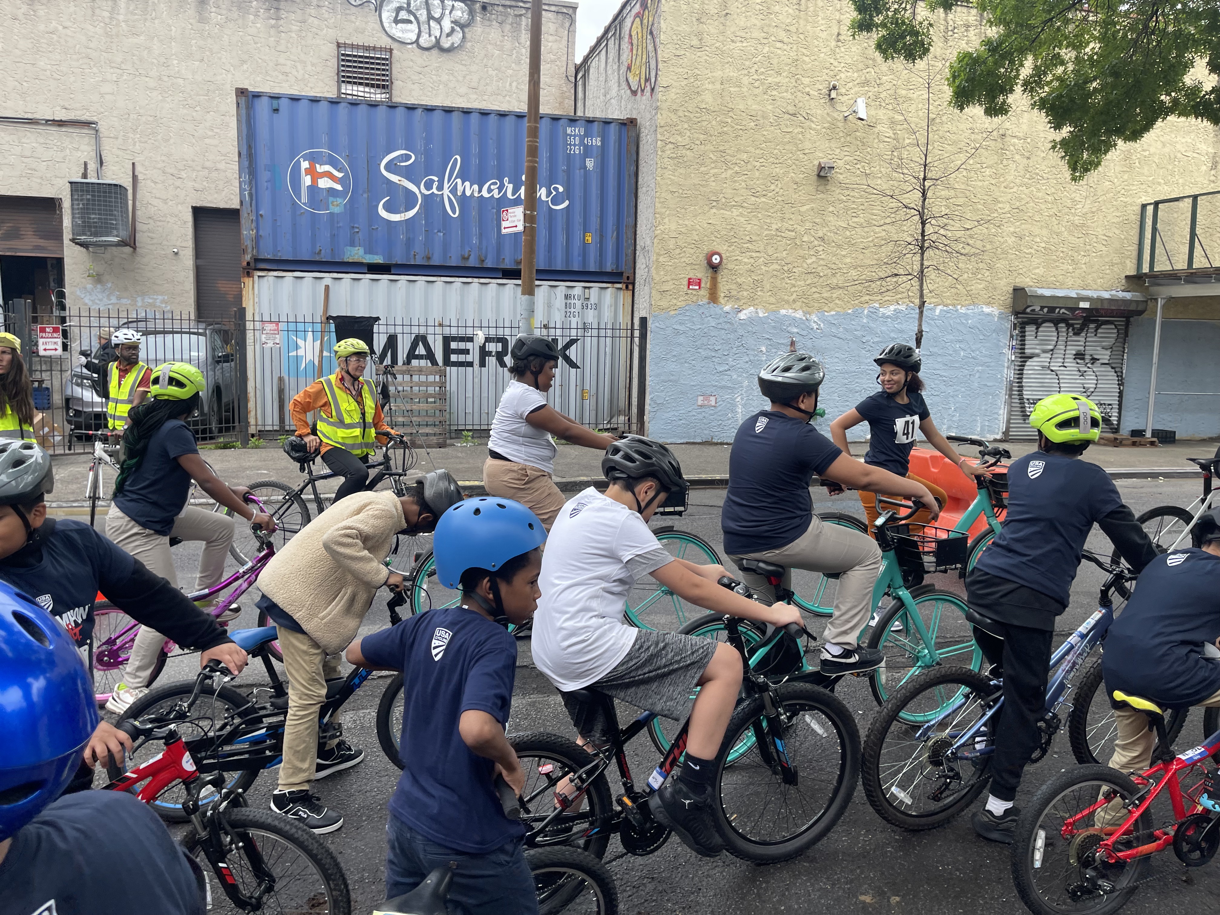 Students and instructors cycling on a street in the Bronx
