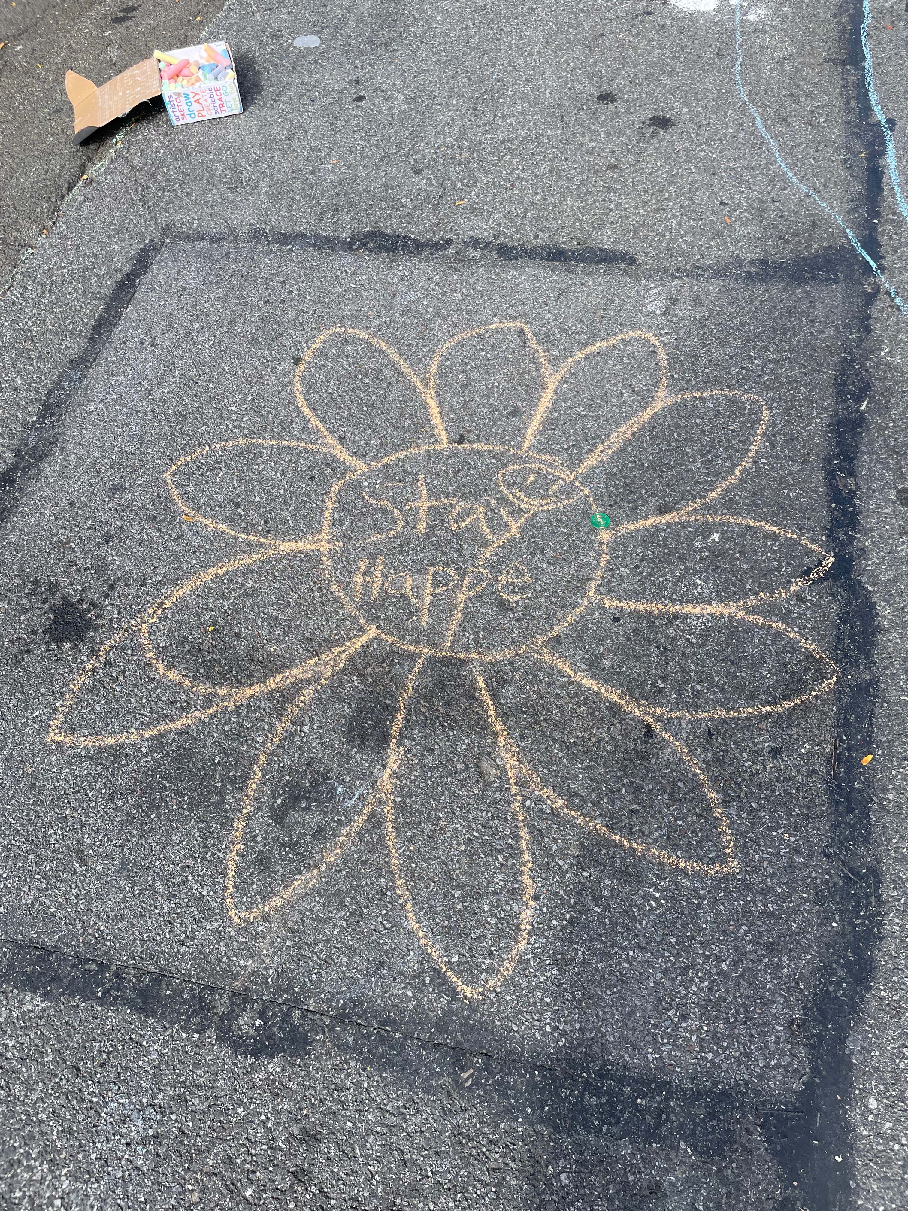 Chalk flower drawing on pavement from a community activity