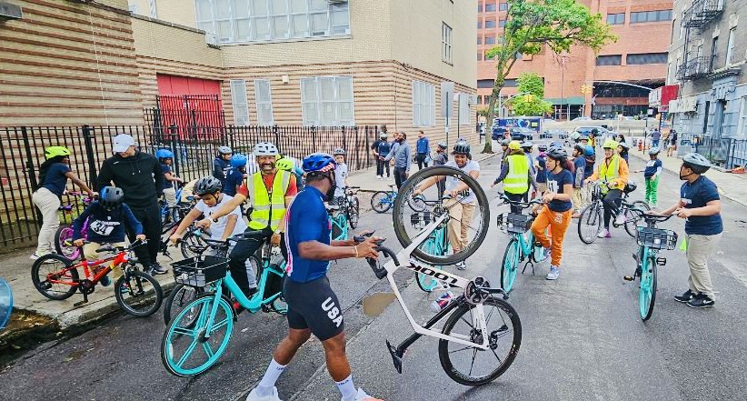 Children and adults with bicycles during a street cycling event